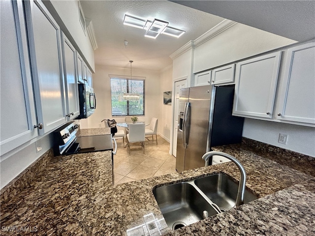 kitchen featuring sink, ornamental molding, light tile patterned flooring, pendant lighting, and appliances with stainless steel finishes