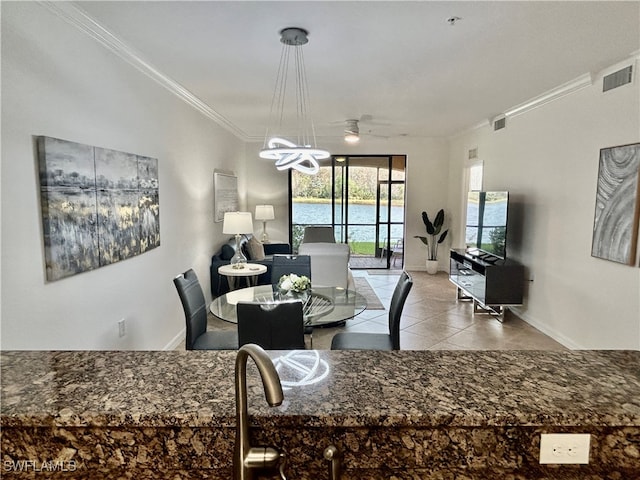 tiled dining room with ornamental molding