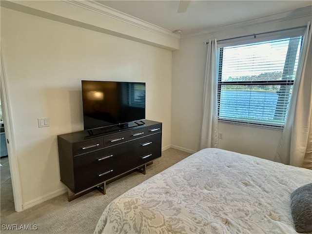 bedroom with light carpet, crown molding, and ceiling fan