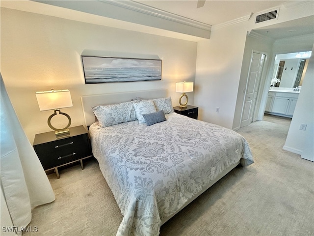 carpeted bedroom featuring ensuite bathroom, ceiling fan, and crown molding