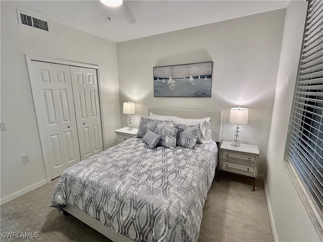 carpeted bedroom with ceiling fan and a closet