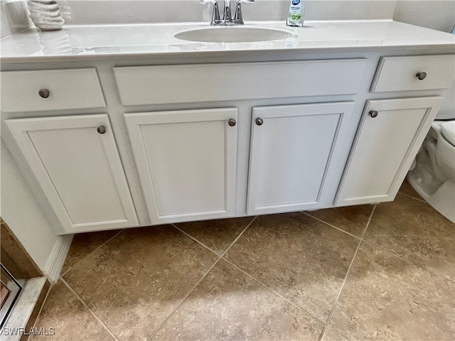 bathroom featuring toilet, vanity, and tile patterned floors