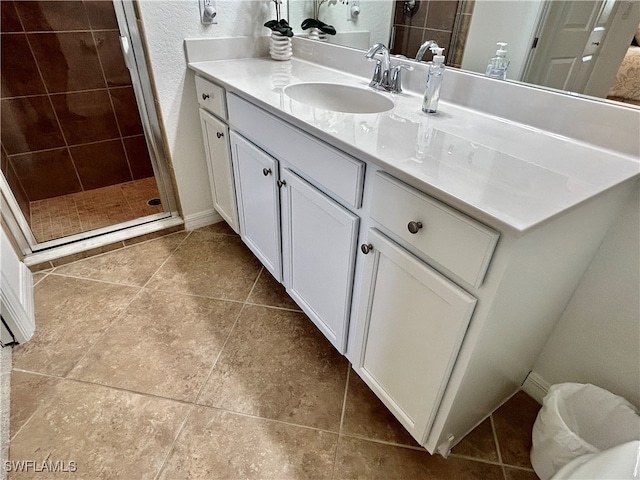 bathroom featuring an enclosed shower, vanity, and tile patterned floors