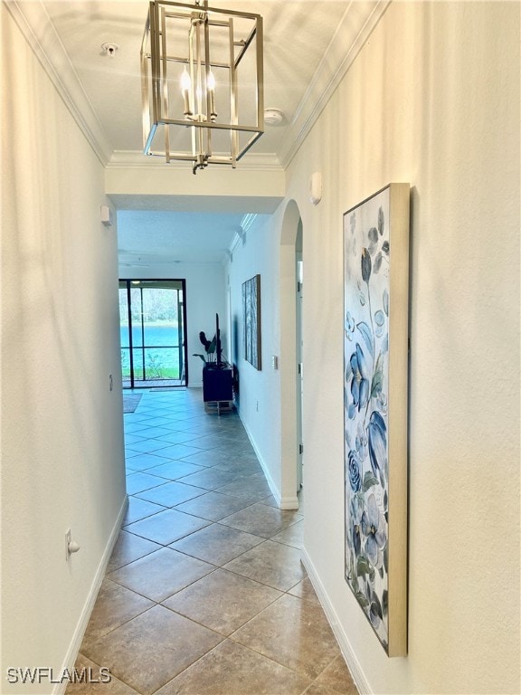 corridor featuring tile patterned flooring and ornamental molding