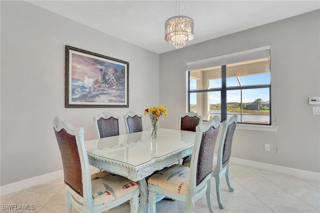 tiled dining space featuring a notable chandelier