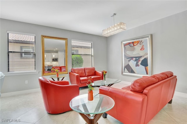 tiled living room featuring an inviting chandelier