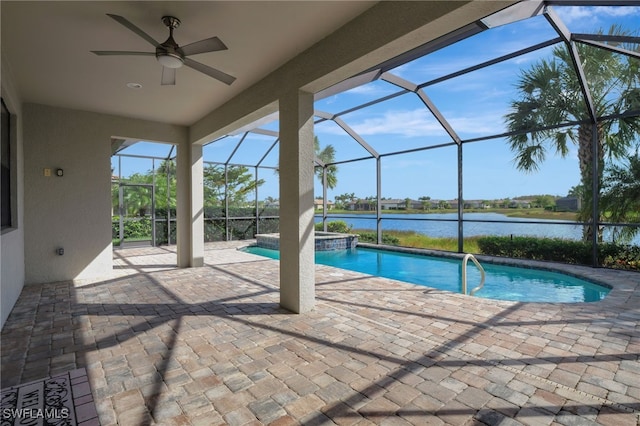 view of swimming pool with ceiling fan, glass enclosure, a water view, and a patio area