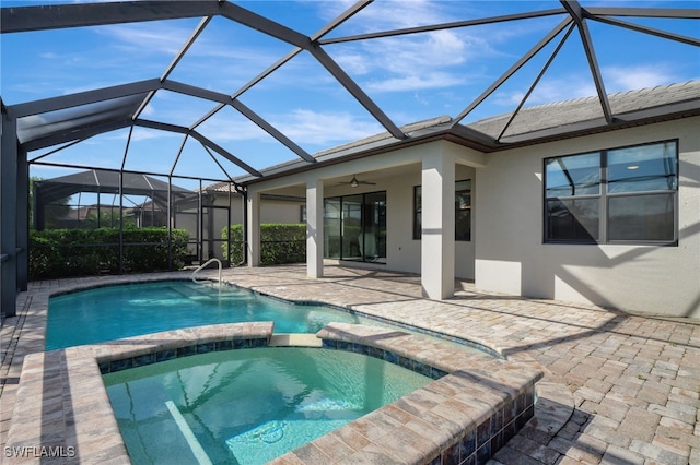 view of pool featuring glass enclosure, a patio, ceiling fan, and an in ground hot tub