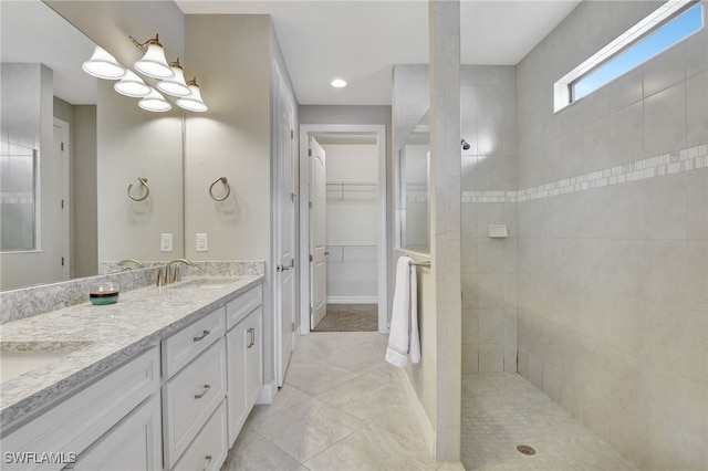 bathroom featuring vanity and a tile shower