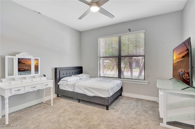 bedroom featuring light colored carpet and ceiling fan