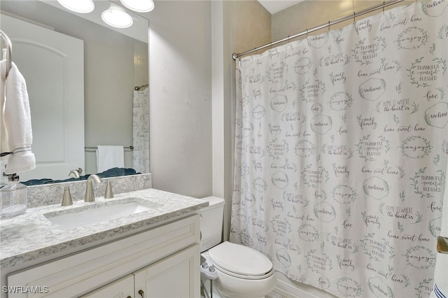 bathroom featuring vanity, toilet, and a shower with shower curtain