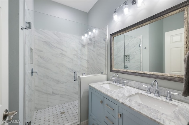 bathroom with vanity and a shower with door