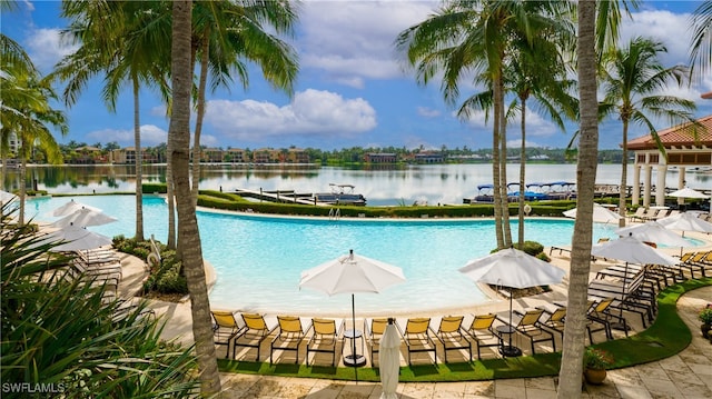 view of swimming pool featuring a water view