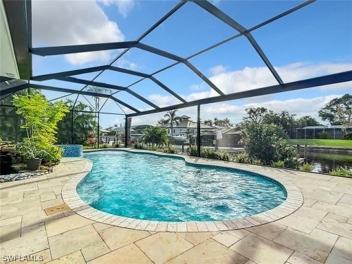 view of swimming pool with a lanai and a patio area