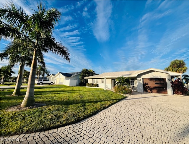 single story home with a front lawn and a garage