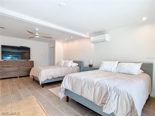 bedroom featuring ceiling fan and a wall mounted air conditioner