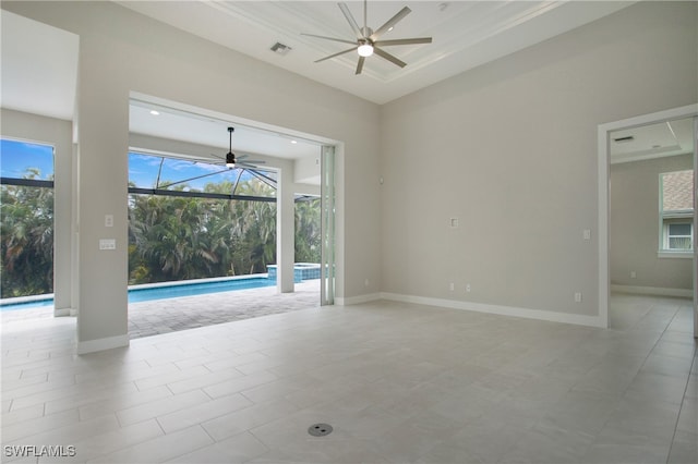 spare room featuring ceiling fan and light tile patterned flooring