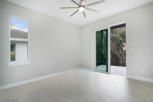 unfurnished room featuring plenty of natural light and ceiling fan