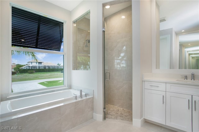 bathroom with vanity, tile patterned floors, and independent shower and bath