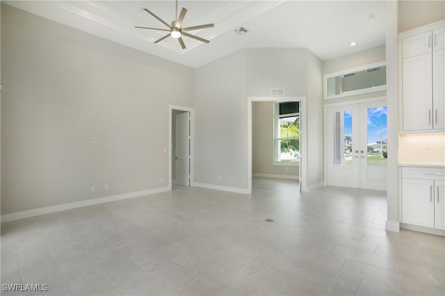 unfurnished living room featuring french doors, ceiling fan, a high ceiling, and light tile patterned floors