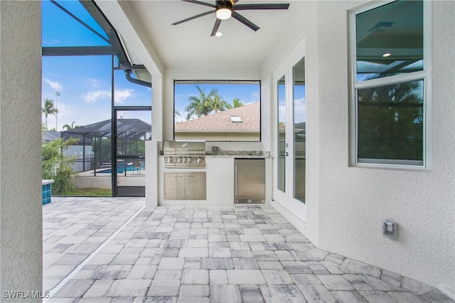 unfurnished sunroom featuring ceiling fan