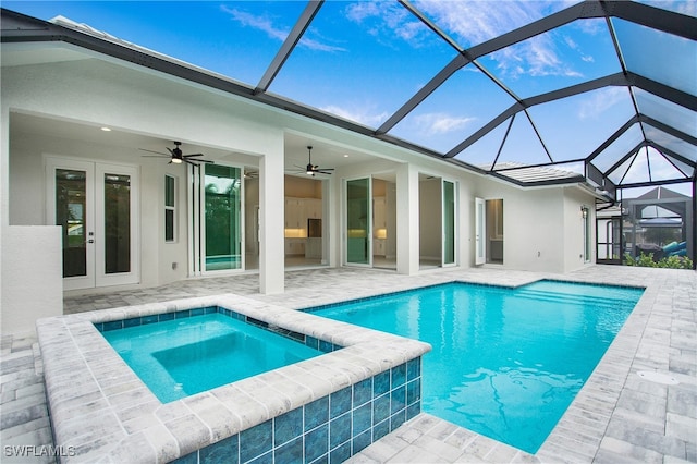 view of swimming pool with french doors, an in ground hot tub, ceiling fan, a patio, and a lanai