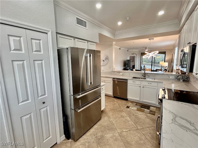 kitchen with white cabinetry, appliances with stainless steel finishes, sink, and ornamental molding