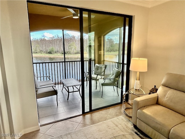 doorway to outside with plenty of natural light, a water view, ceiling fan, and light tile patterned floors