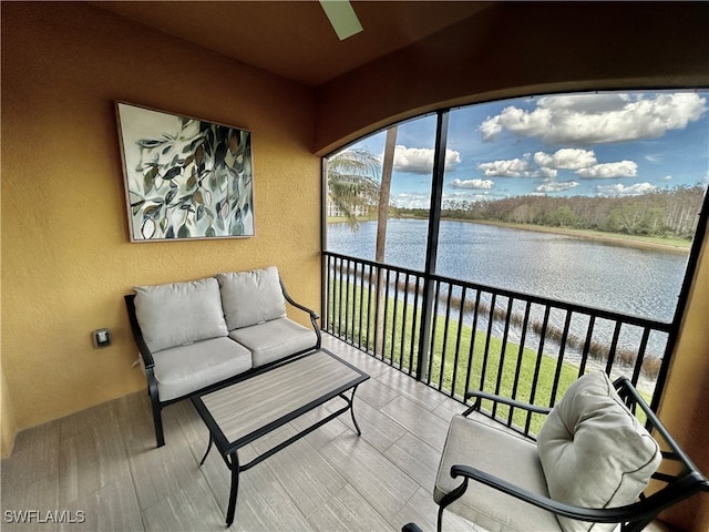 sunroom / solarium featuring a water view and plenty of natural light