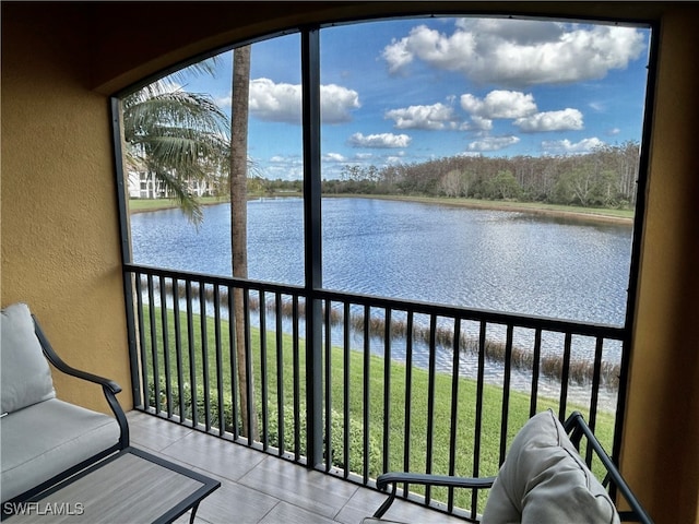 unfurnished sunroom featuring a water view