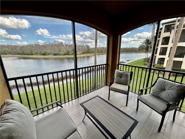 sunroom / solarium featuring a water view