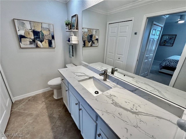 bathroom with tile patterned flooring, vanity, toilet, and ornamental molding