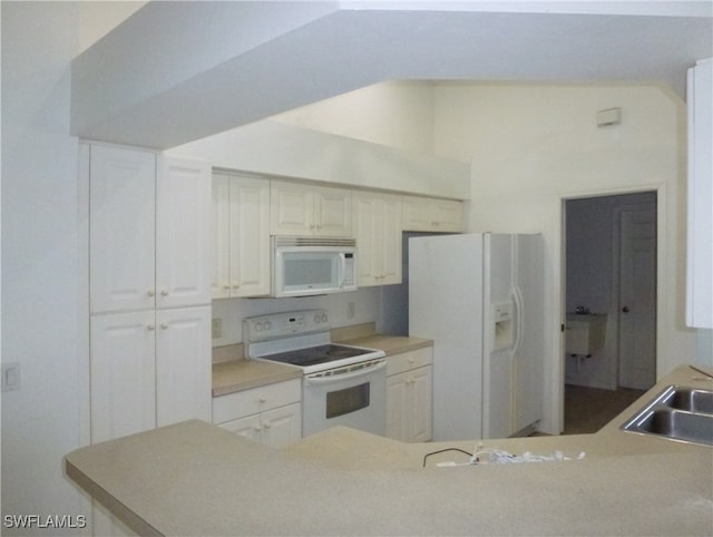 kitchen featuring kitchen peninsula, white appliances, sink, and white cabinets