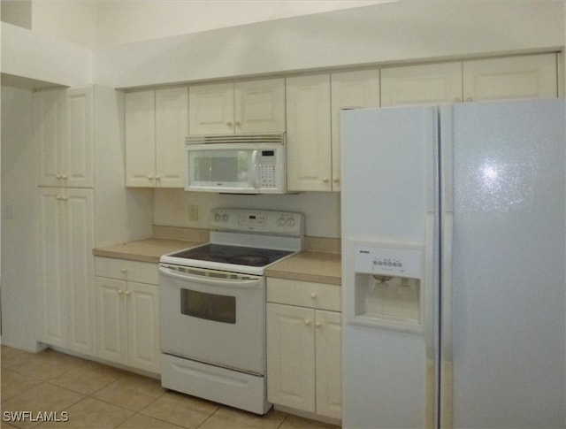 kitchen featuring white appliances and light tile patterned flooring