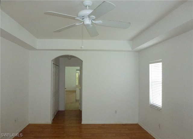 spare room with wood-type flooring and ceiling fan