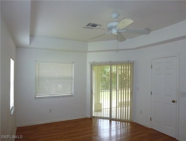 spare room with hardwood / wood-style flooring and ceiling fan