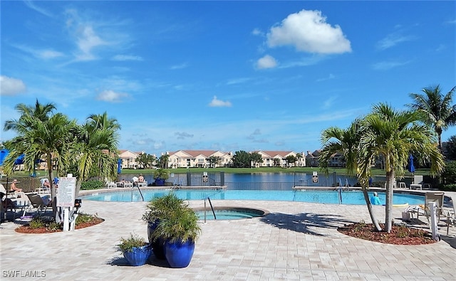 view of pool with a patio and a water view