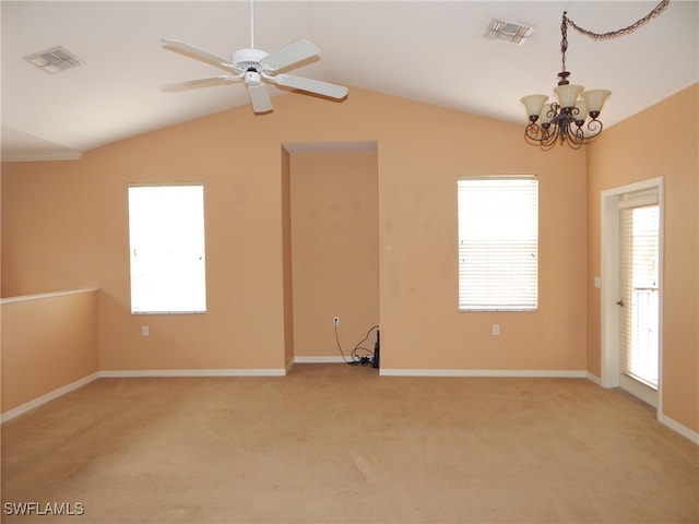 spare room with ceiling fan with notable chandelier, light carpet, and vaulted ceiling