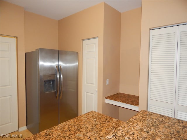 kitchen featuring stainless steel refrigerator with ice dispenser