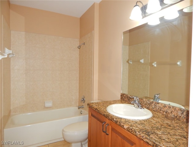 full bathroom featuring toilet, vanity, tiled shower / bath, and tile patterned flooring