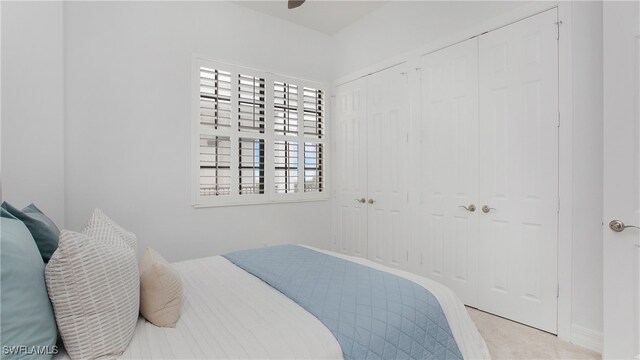 bedroom featuring ceiling fan and light carpet