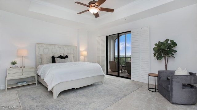 bedroom with access to outside, ceiling fan, and a raised ceiling