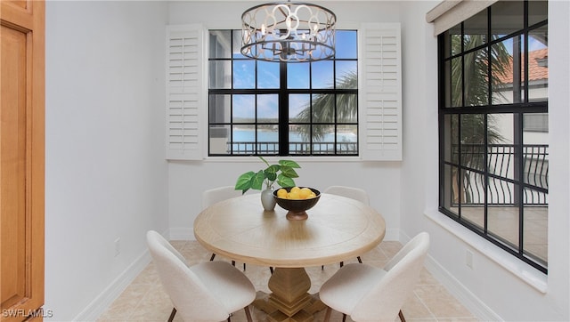 dining space featuring an inviting chandelier and tile patterned floors