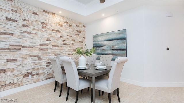 tiled dining space featuring ornamental molding