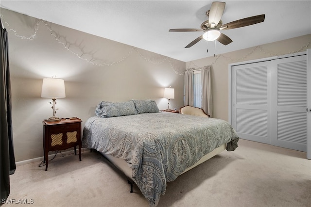 carpeted bedroom featuring a closet and ceiling fan