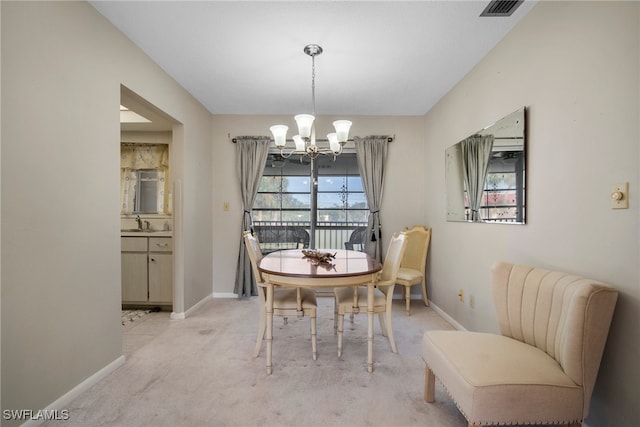 carpeted dining space featuring a healthy amount of sunlight, sink, and an inviting chandelier