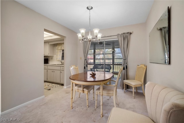 dining space featuring light colored carpet, sink, and an inviting chandelier