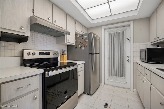 kitchen with backsplash, appliances with stainless steel finishes, and light tile patterned flooring