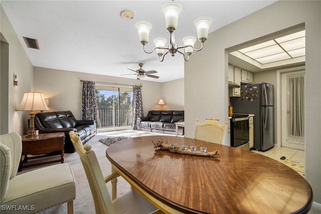 dining area featuring ceiling fan with notable chandelier and light tile patterned floors