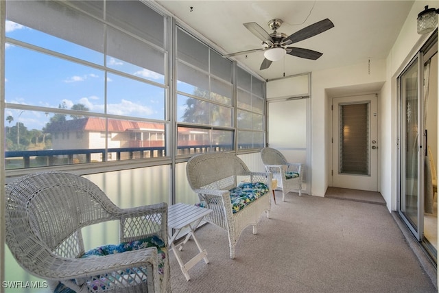 sunroom / solarium featuring ceiling fan